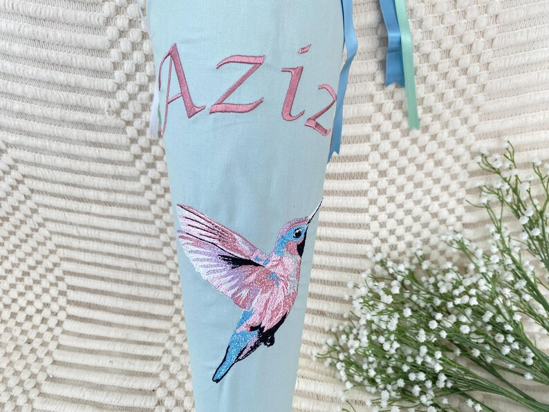 Schultüte mit buntem Kolibri und personalisierter Stickerei gerade ausgerichtet